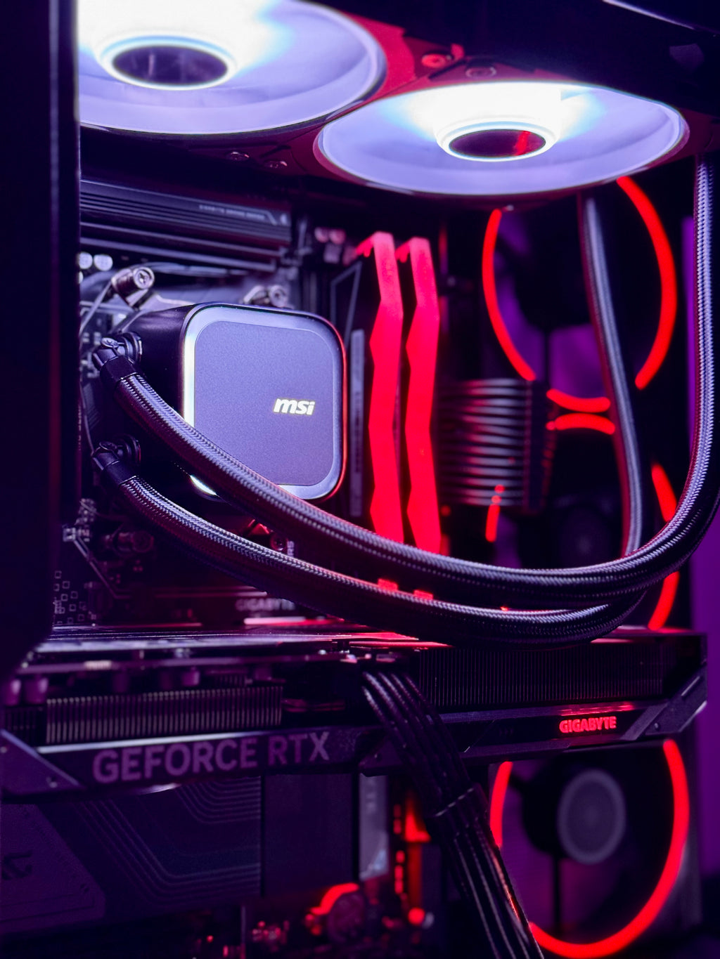 Close-up of a computer motherboard with MSI graphics card and red LED lighting