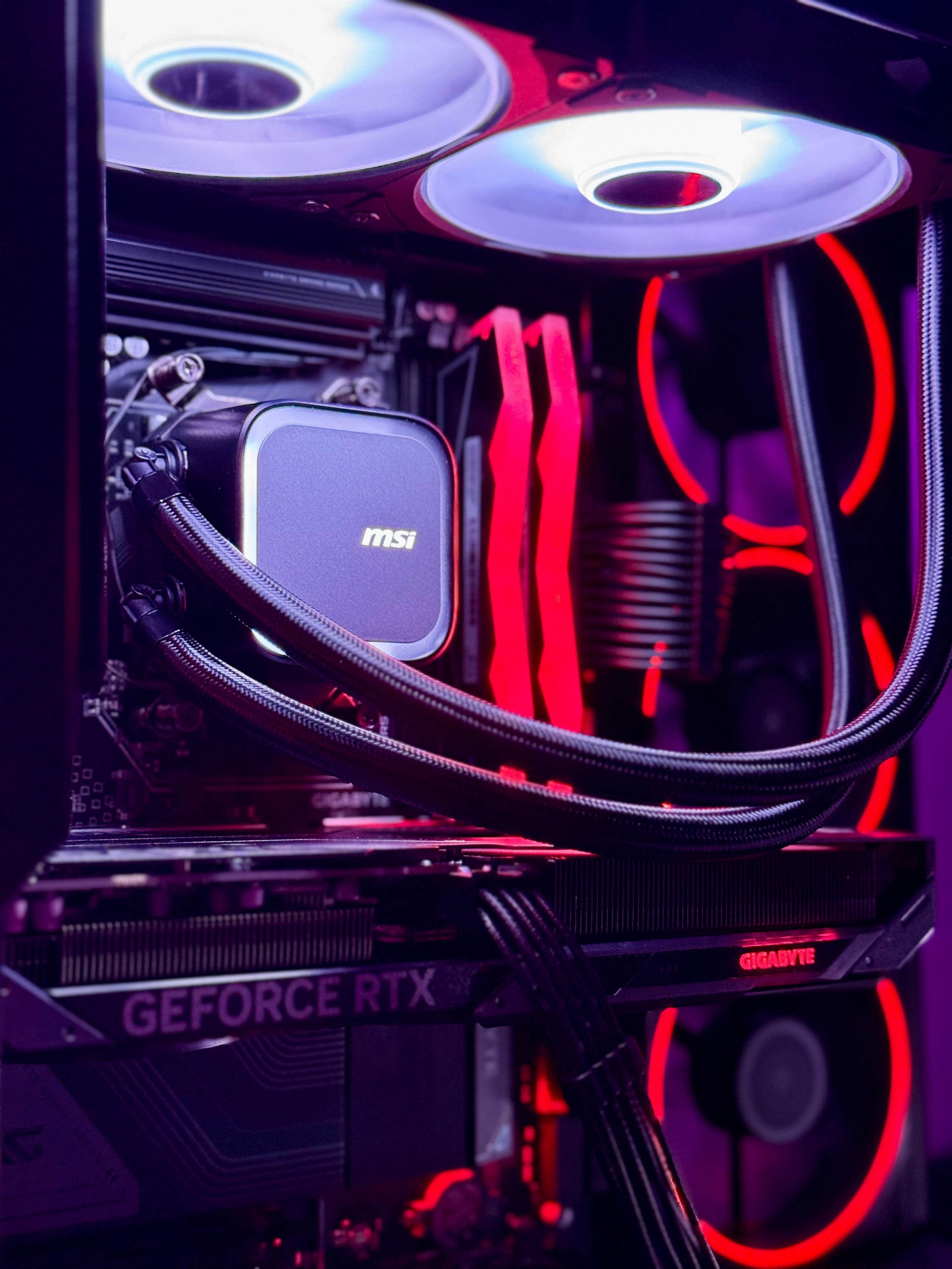 Close-up of a computer motherboard with MSI graphics card and red LED lighting