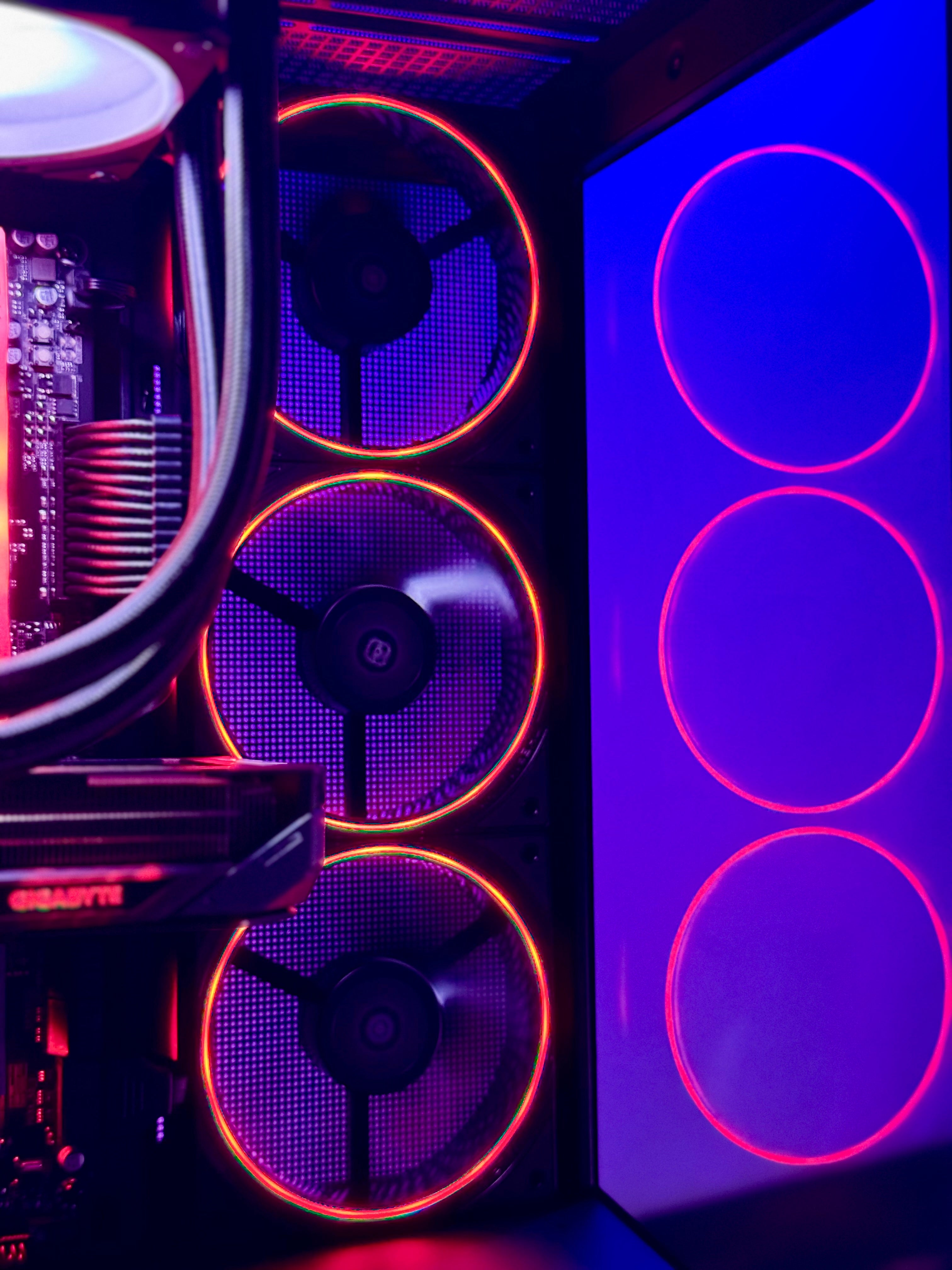 Close-up of a computer case with glowing fans and RGB lighting