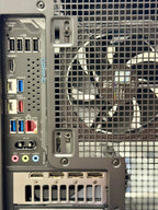Back view of a computer case with ports and a fan.
