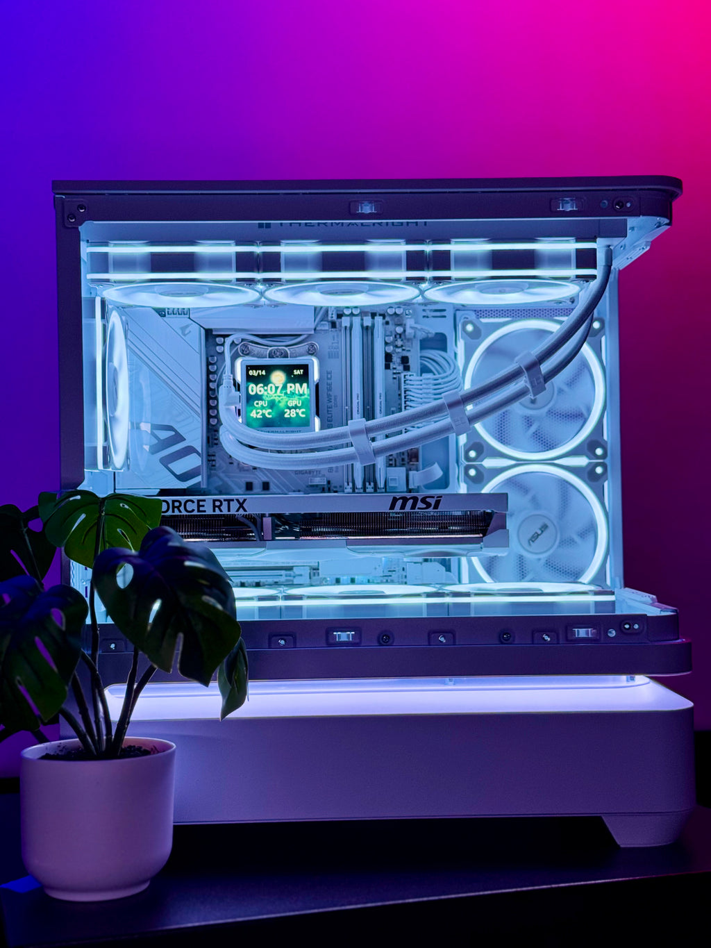 Glossy computer case with visible hardware on a gradient purple and pink background