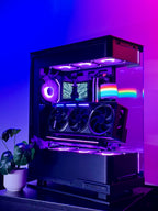 Glossy gaming PC case with RGB lighting on a reflective surface.
