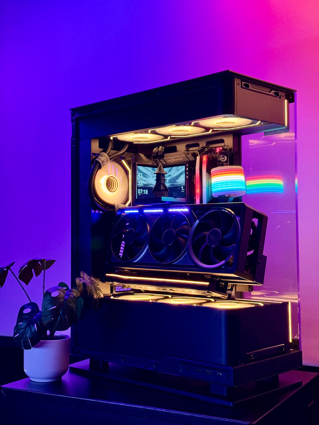 Open computer case with RGB lighting on a purple gradient background