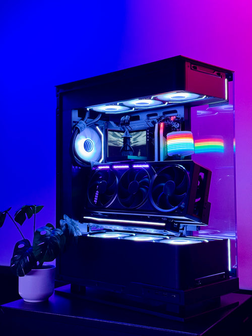 Custom-built computer case with RGB lighting on a purple background