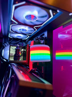 Close-up of a computer case with RGB lighting and rainbow-colored components.