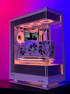 Computer case with transparent side panel on a gradient purple and pink background