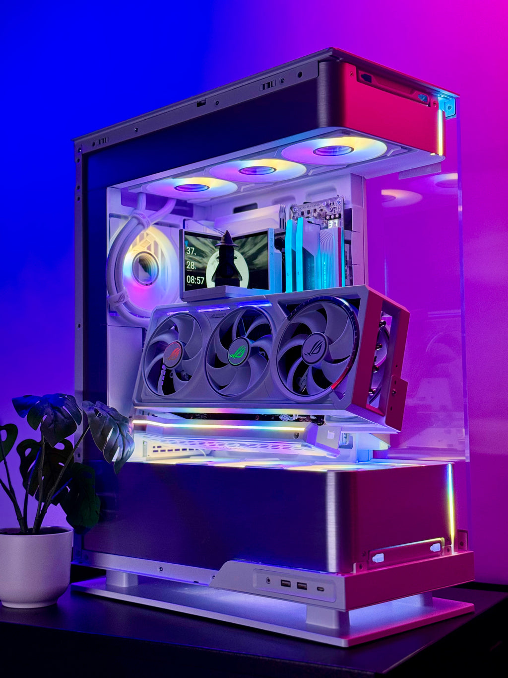 Glossy gaming PC case with RGB lighting on a purple background