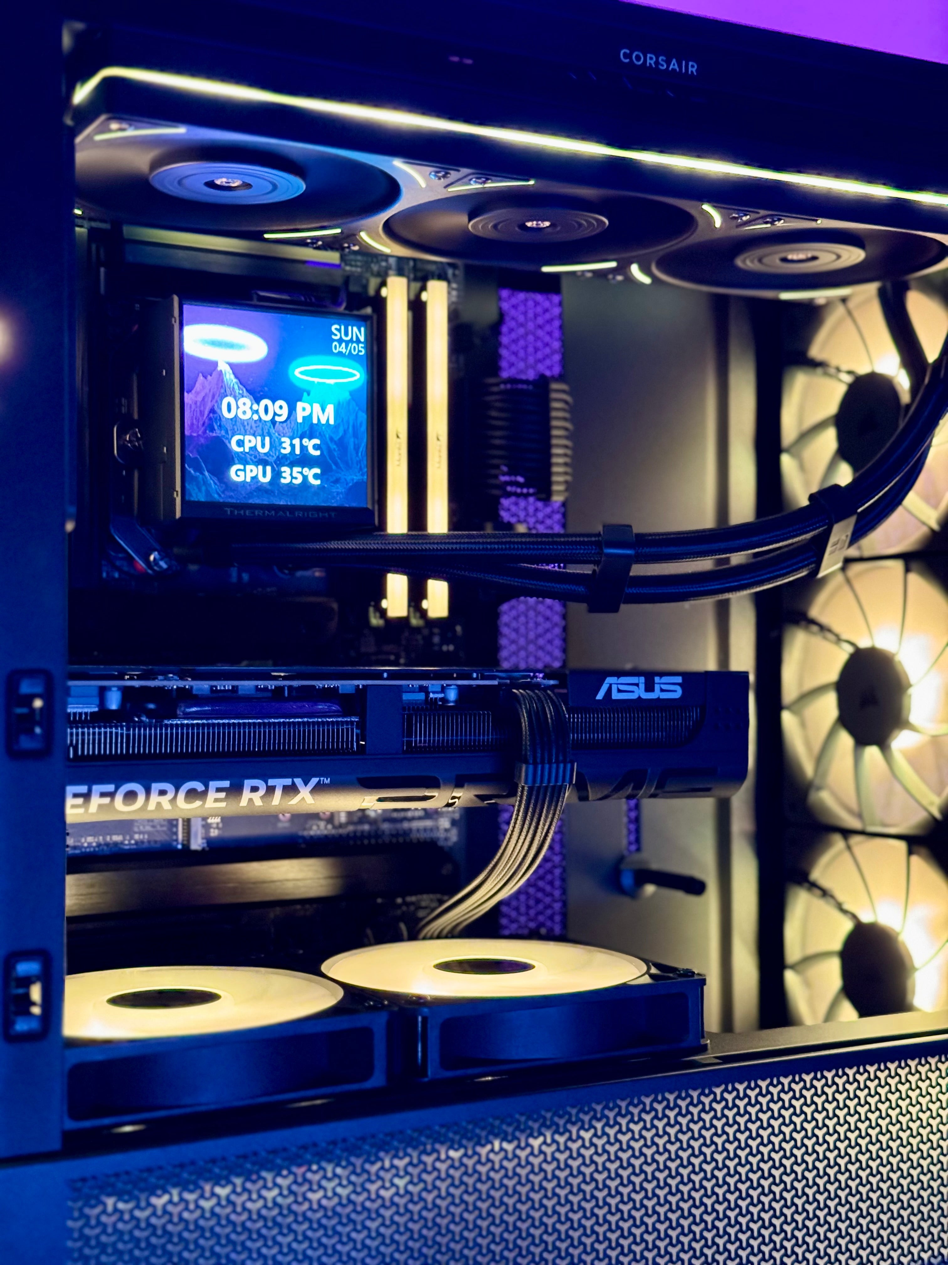Open computer case with visible hardware components and ASUS branding.