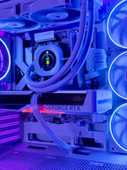 A close-up of a high-performance PC interior with a liquid CPU cooler, multiple fans with blue LED lighting, and a GeForce RTX graphics card under purple and blue ambient lighting.