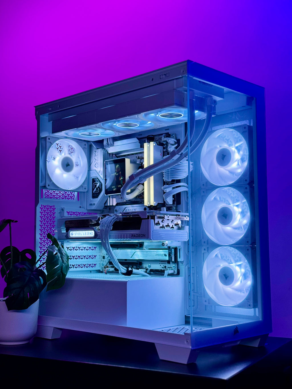 A custom-built desktop PC inside a transparent side-panel computer case, illuminated with cool white and blue LED lighting, set against a vibrant purple and blue background.