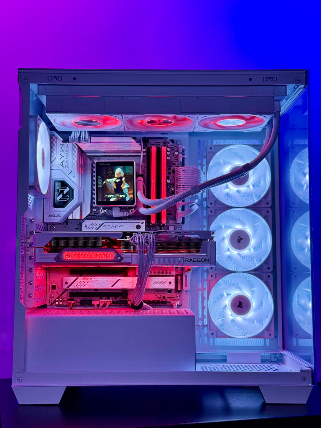 A white custom PC tower with a glass side panel, showcasing a highly customized internal setup with RGB lighting. The interior features a white and silver motherboard, a liquid CPU cooler with red LED tubes, a graphics card, and multiple white and red LED fans.