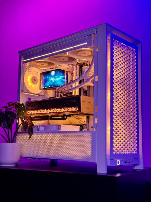 A white custom PC tower with a glass side panel, showcasing an internal liquid CPU cooler, fans, and a graphics card, illuminated by purple and orange LED lighting against a purple background.