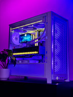 A custom white PC tower with a glass side panel, showcasing internal components illuminated by purple and blue LED lighting, set against a dark background with a small potted plant in the foreground.