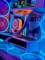 A close-up of a custom PC build with neon RGB lighting, featuring a white GeForce RTX graphics card, a liquid CPU cooler with an orange accent, and multiple fans glowing in blue and purple.