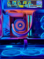 Close-up of a custom RGB PC build featuring a Corsair liquid CPU cooler with a blue and orange patterned radiator, illuminated by purple and blue LED lighting inside a glass-sided case.