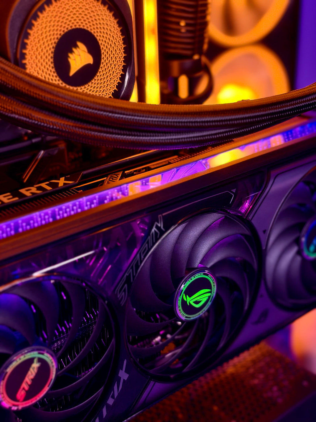 Close-up of a high-performance gaming PC interior featuring an RTX graphics card with glowing RGB fans, a liquid CPU cooler, and a Corsair radiator under dramatic purple and orange lighting.