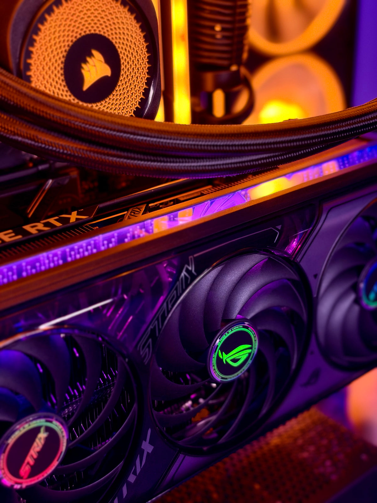 Close-up of a high-performance gaming PC interior featuring an RTX graphics card with glowing RGB fans, a liquid CPU cooler, and a Corsair radiator under dramatic purple and orange lighting.
